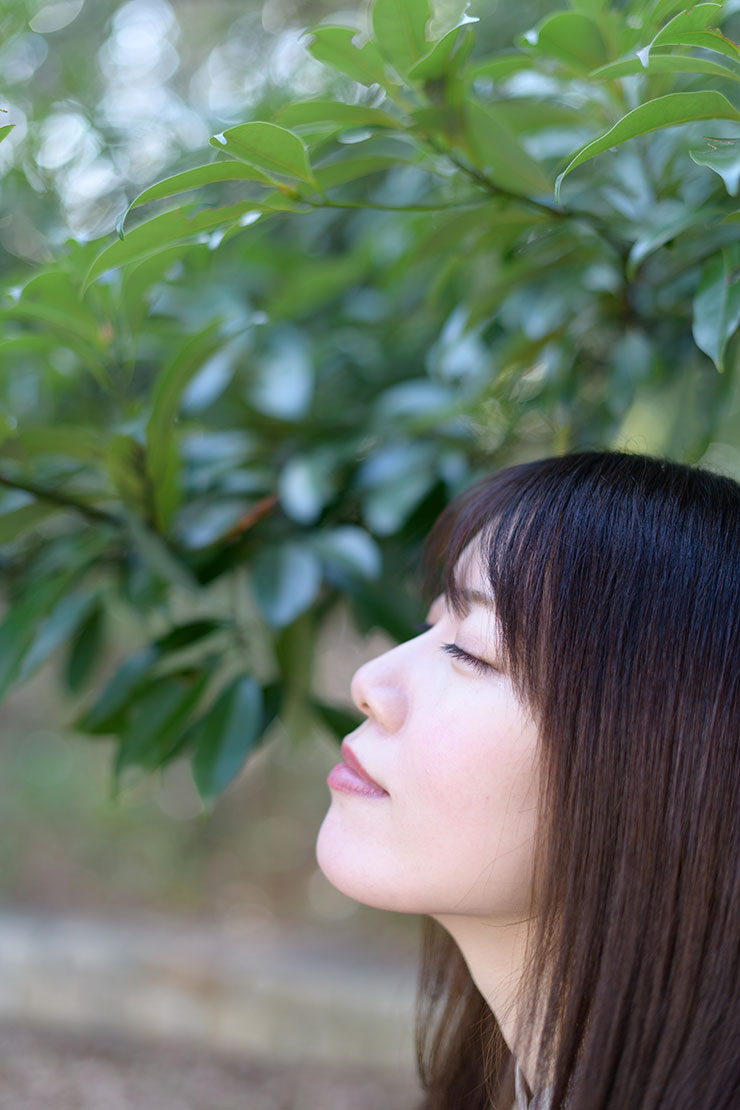 ニコン D850・AF-S NIKKOR 50mm f/1.4Gで撮影した木の下で目を瞑る女性の画像