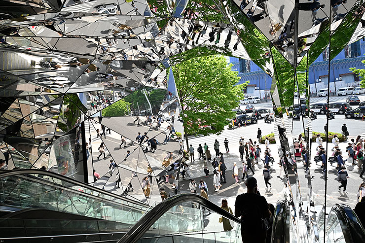 SIGMA 16mm F1.4 DC DN | Contemporaryで撮影した街中の人々が建物に反射して映っている様子